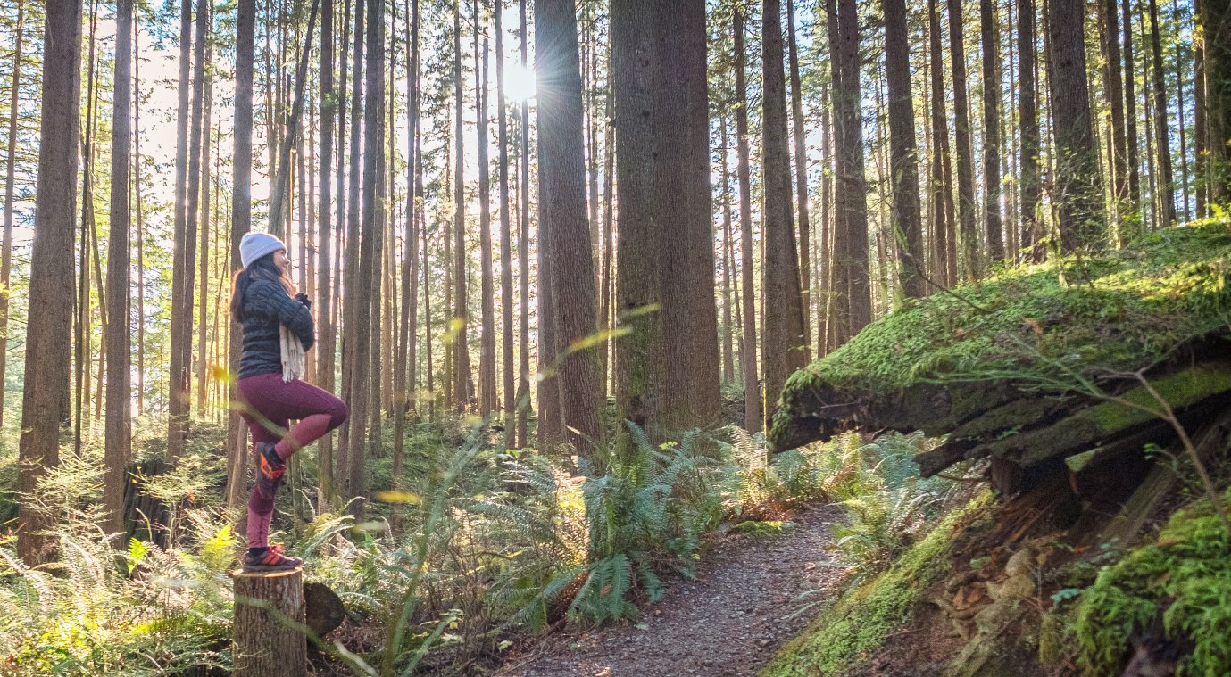 A woman balancing on a log in Vail CO