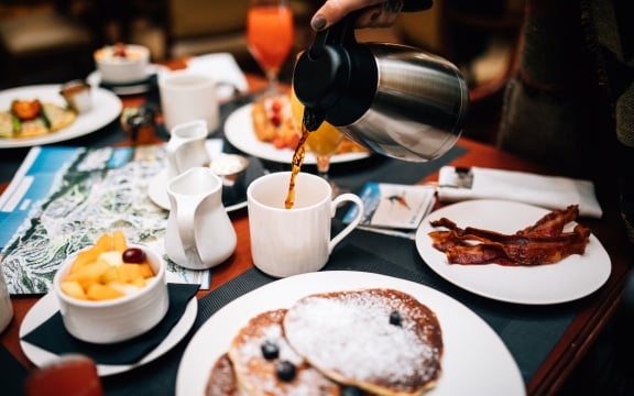 Bacon, pancakes, fruit and coffee served for breakfast at The Hythe Vail CO