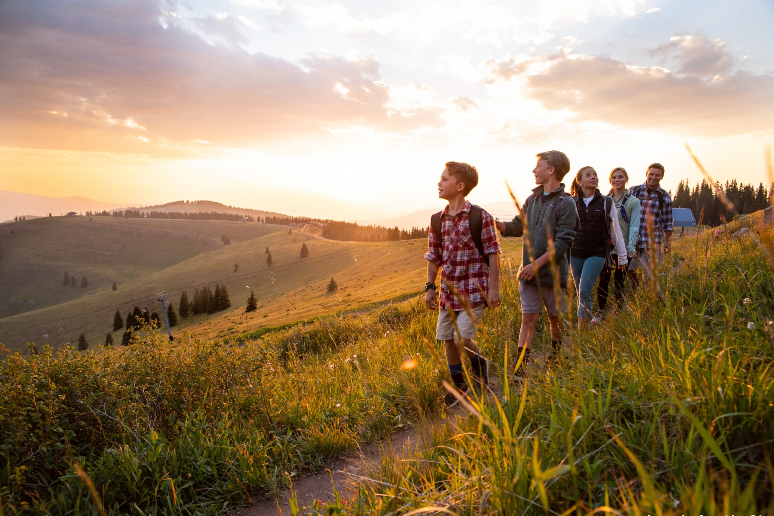 A family hiking a trail in Vail CO