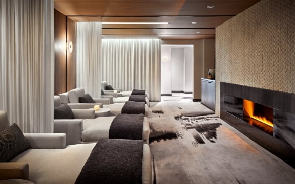 A row of beds to relax in front of the fireplace at The Spa in The Hythe Vail CO