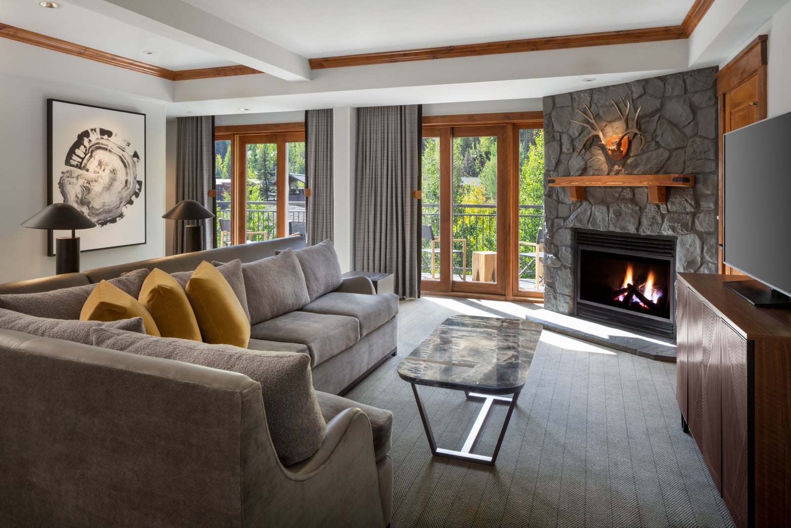 The living area and fireplace from the Timberline Suite at The Hythe Vail