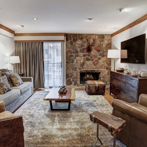 The living room and fireplace in a residence suite at The Hythe Vail CO