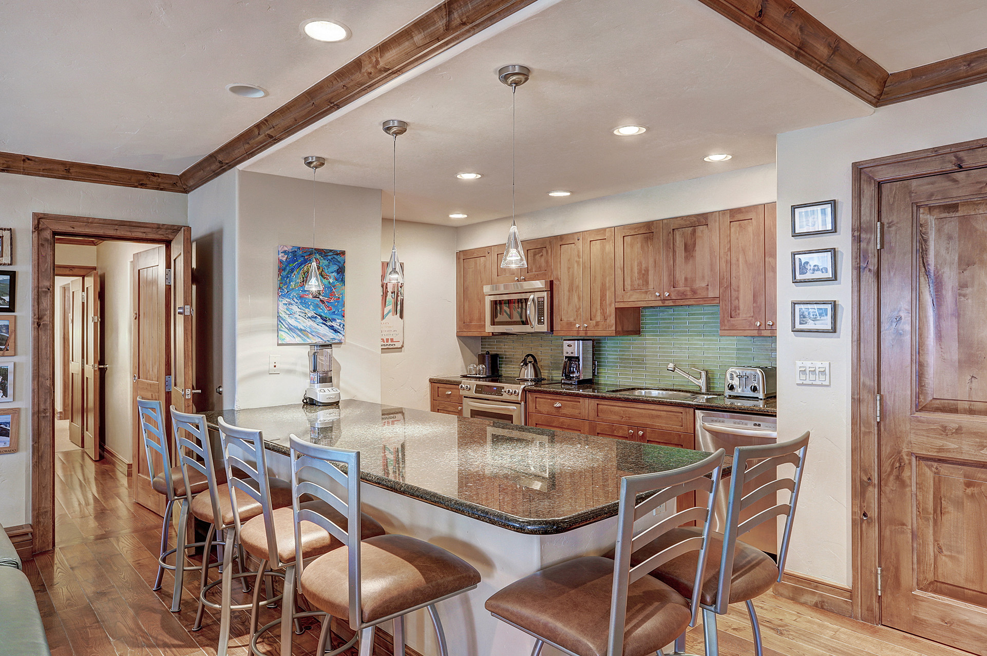 The dining table and kitchen of a 3 bedroom suite at The Hythe Vail CO