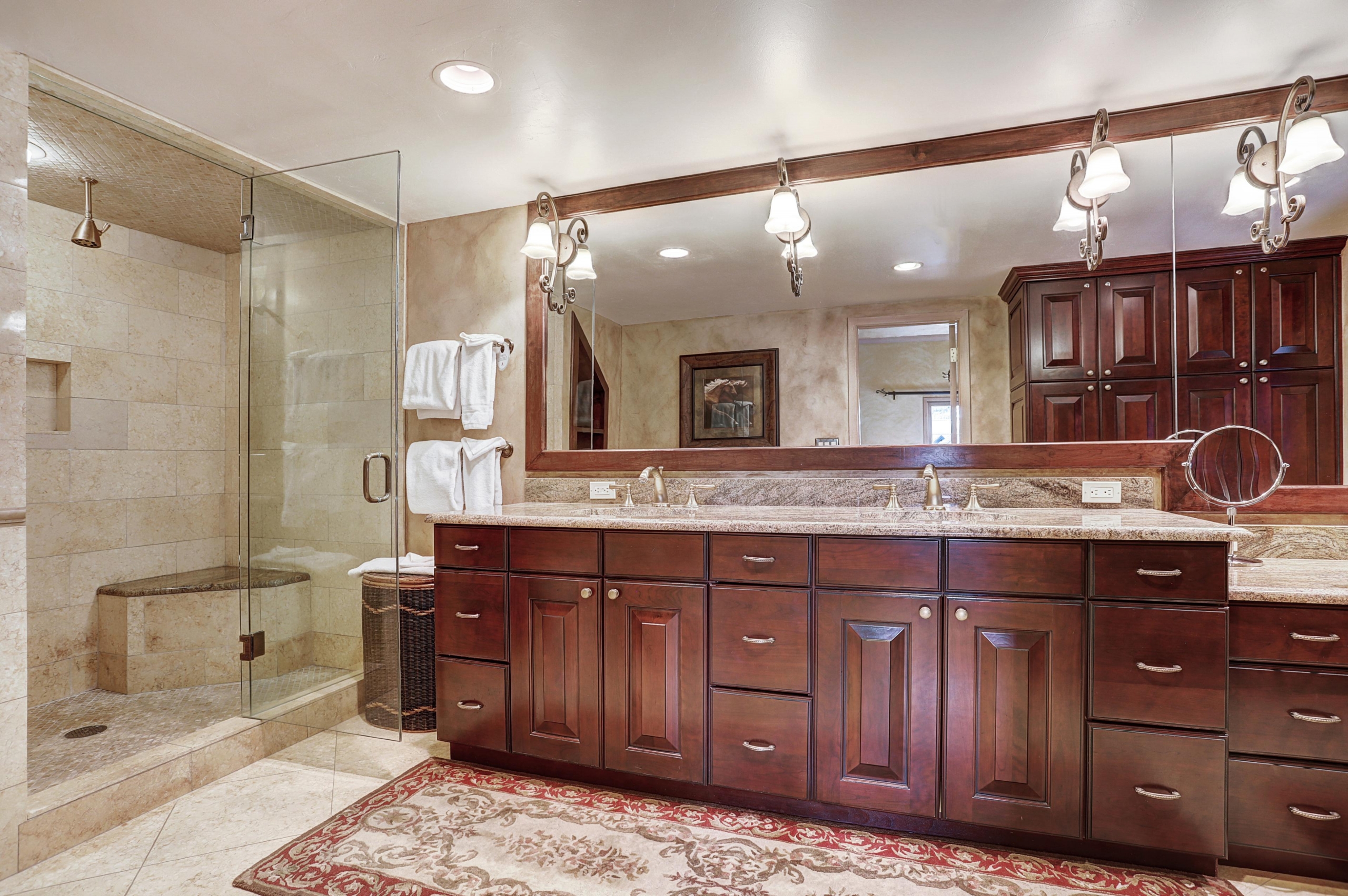 a large bathroom with double sinks and a large shower
