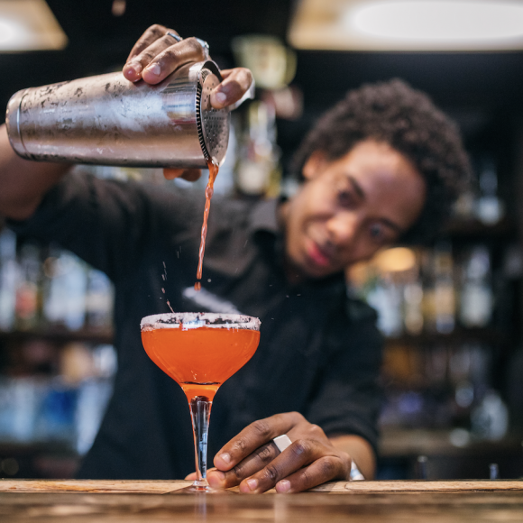 A bartender mixing a drink at The Hythe Vail CO