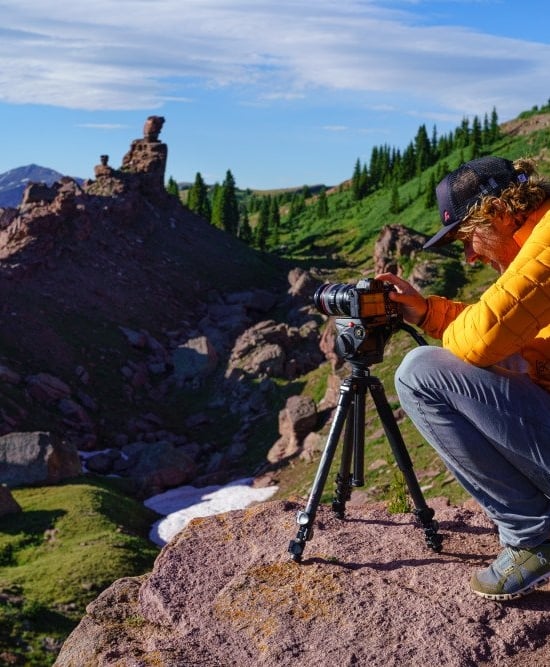 Photographer looking through the lens of a camera