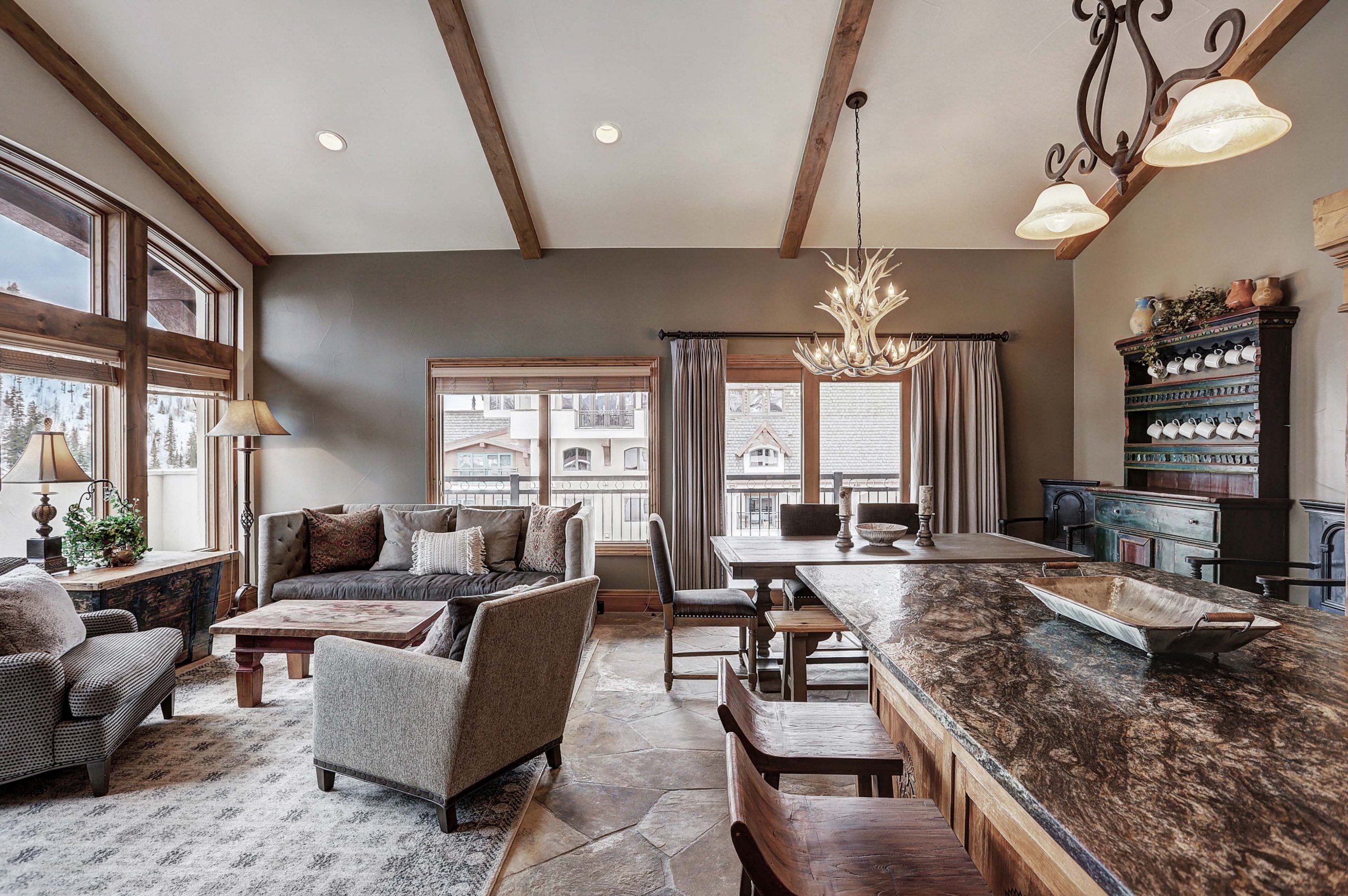 a large living room with seating and a dining area