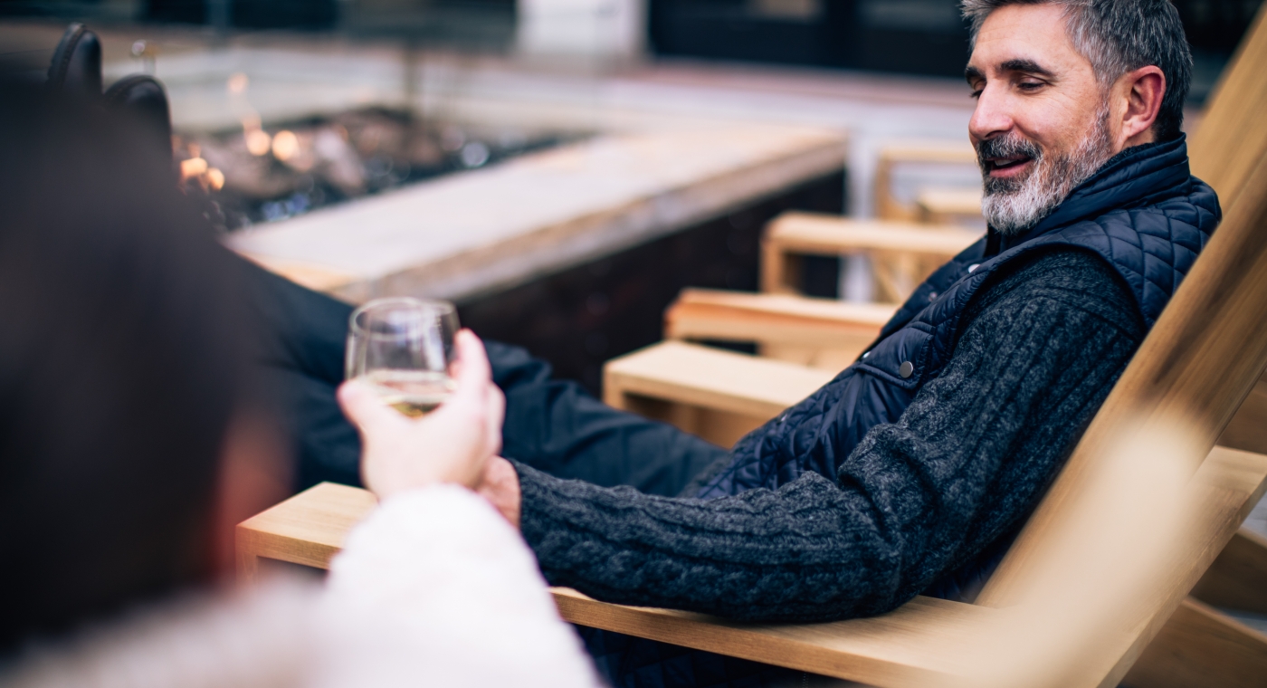 man sitting outdoors near a firepit