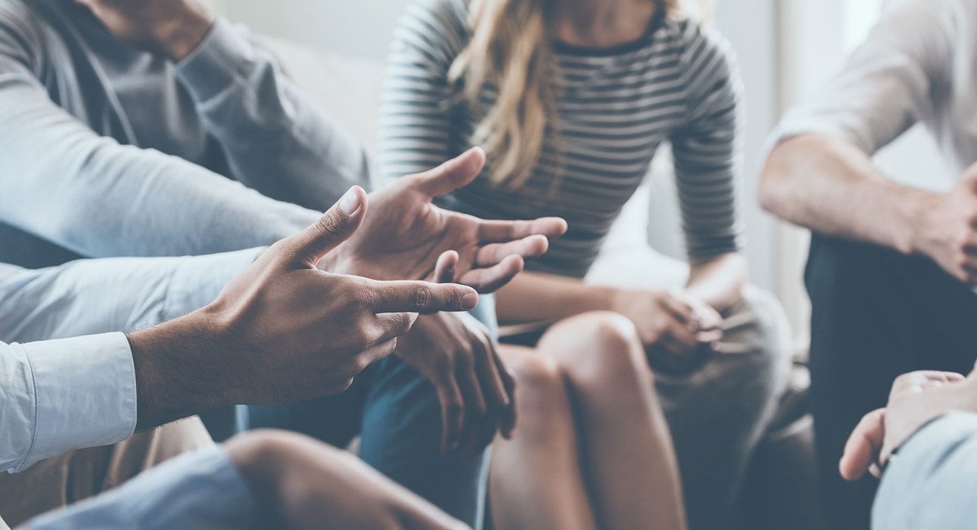 people sitting around a table, closeup on hands