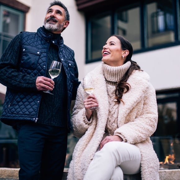 couple sitting outdoors enjoying a beverage