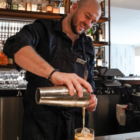 Bartender pouring cocktail